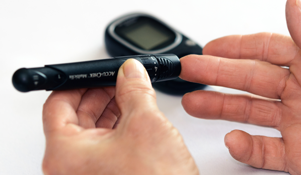 a person taking their blood sugar level